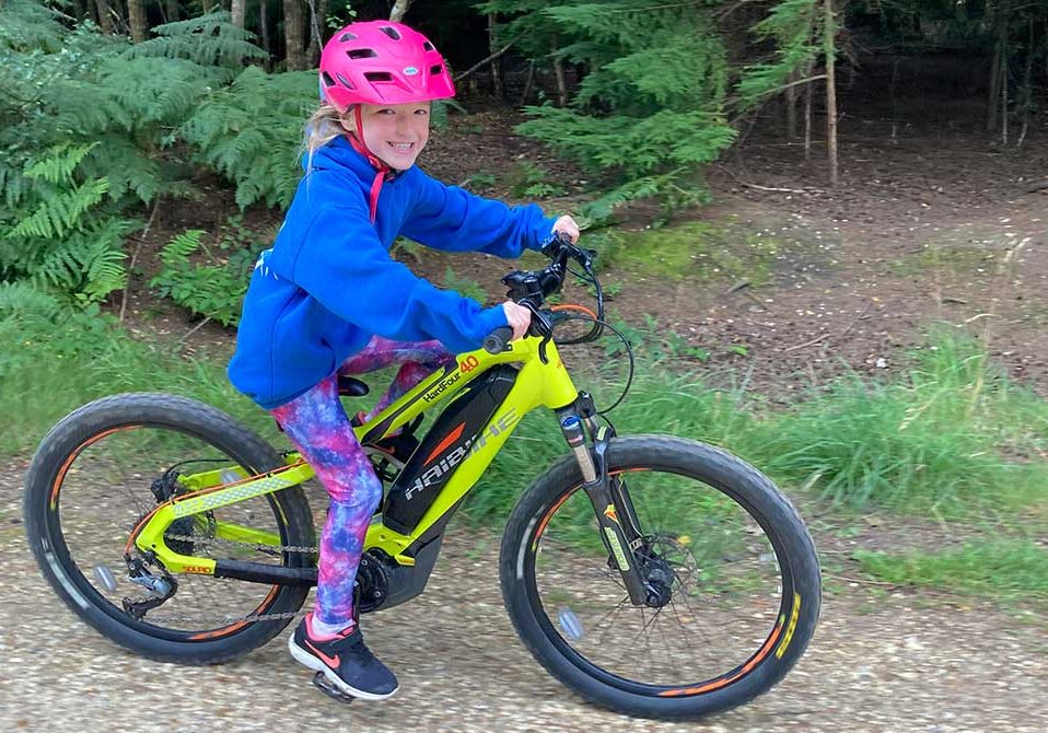a girl riding a kids e mountain bike from southern e bike rentals